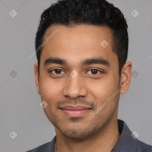 Joyful latino young-adult male with short  black hair and brown eyes