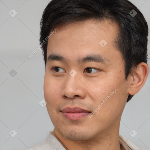 Joyful asian young-adult male with short  brown hair and brown eyes