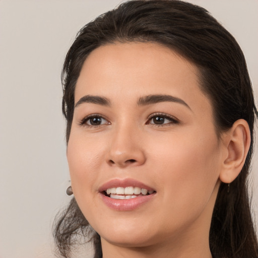 Joyful white young-adult female with long  brown hair and brown eyes