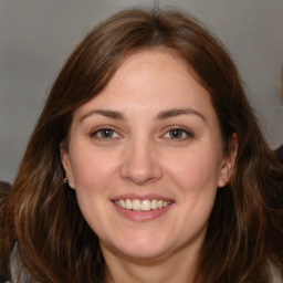 Joyful white young-adult female with medium  brown hair and brown eyes