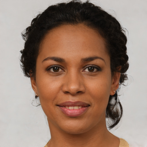 Joyful latino young-adult female with medium  brown hair and brown eyes