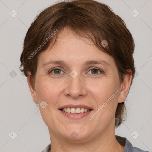 Joyful white adult female with medium  brown hair and grey eyes