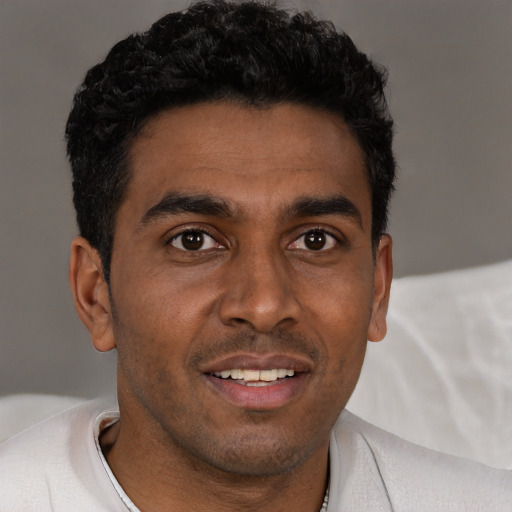 Joyful white young-adult male with short  black hair and brown eyes