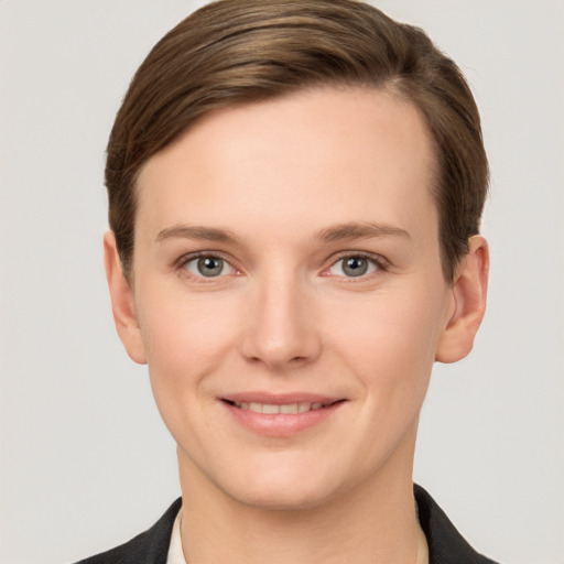 Joyful white young-adult female with short  brown hair and grey eyes