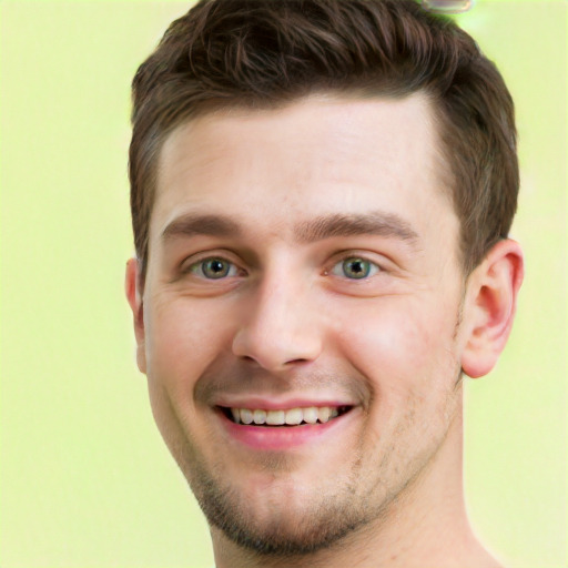 Joyful white young-adult male with short  brown hair and green eyes