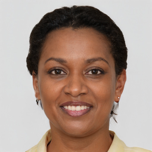 Joyful black young-adult female with short  brown hair and brown eyes