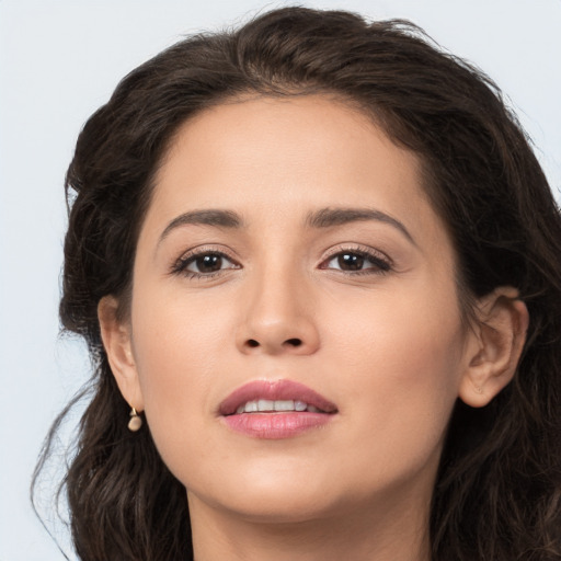 Joyful white young-adult female with long  brown hair and brown eyes