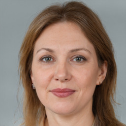 Joyful white adult female with long  brown hair and brown eyes