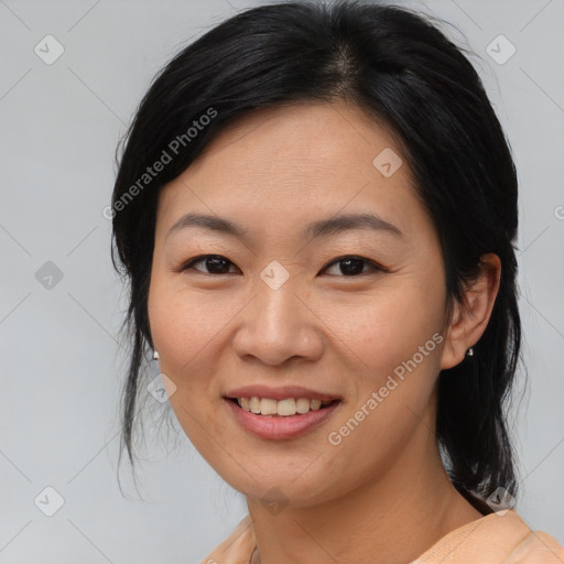 Joyful asian young-adult female with medium  black hair and brown eyes