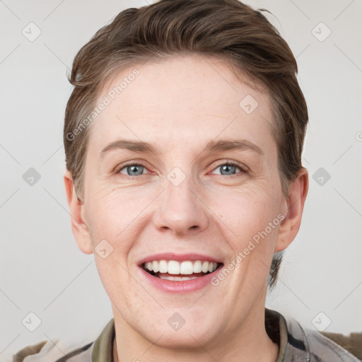 Joyful white adult female with short  brown hair and grey eyes