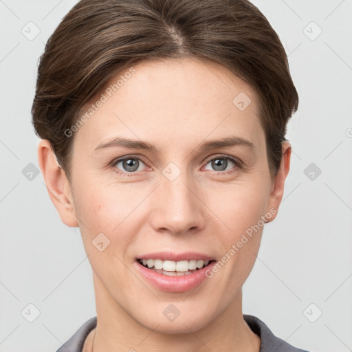 Joyful white young-adult female with short  brown hair and grey eyes