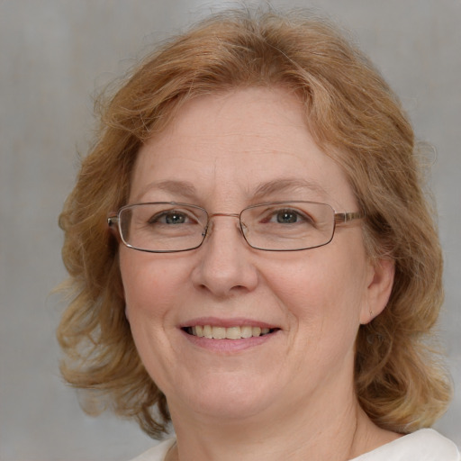 Joyful white middle-aged female with medium  brown hair and blue eyes