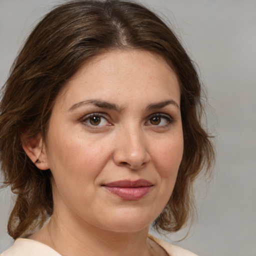 Joyful white adult female with medium  brown hair and brown eyes