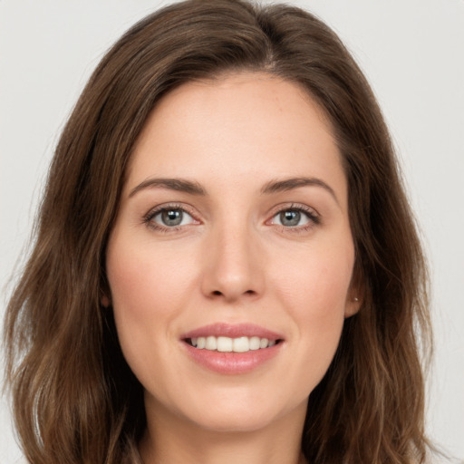 Joyful white young-adult female with long  brown hair and green eyes