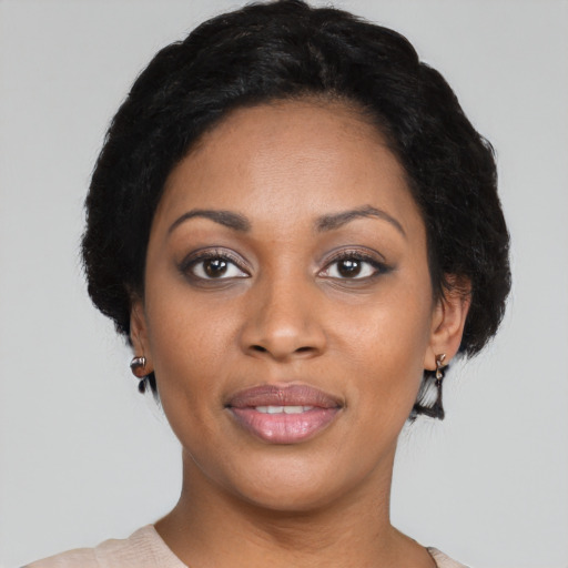 Joyful black young-adult female with short  black hair and brown eyes