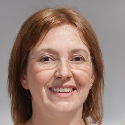 Joyful white adult female with medium  brown hair and blue eyes