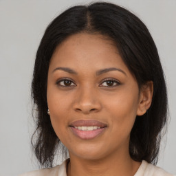 Joyful black young-adult female with medium  brown hair and brown eyes