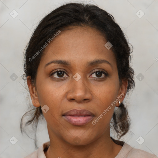 Joyful black adult female with medium  brown hair and brown eyes