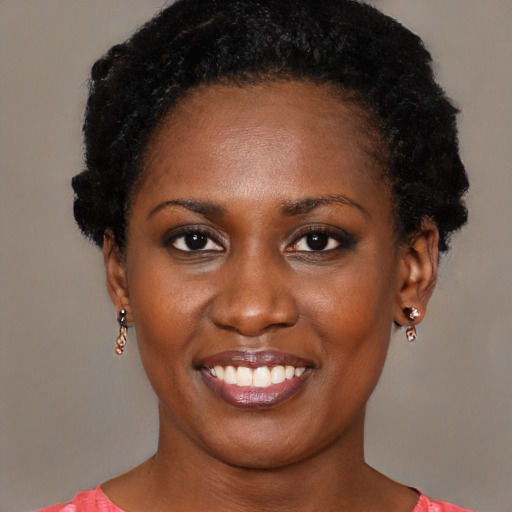 Joyful black young-adult female with short  black hair and brown eyes