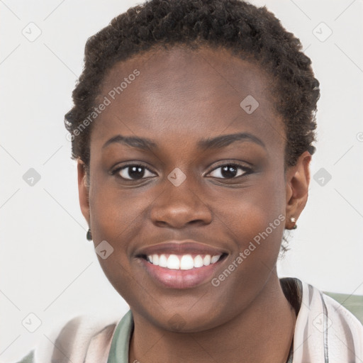 Joyful black young-adult female with short  brown hair and brown eyes