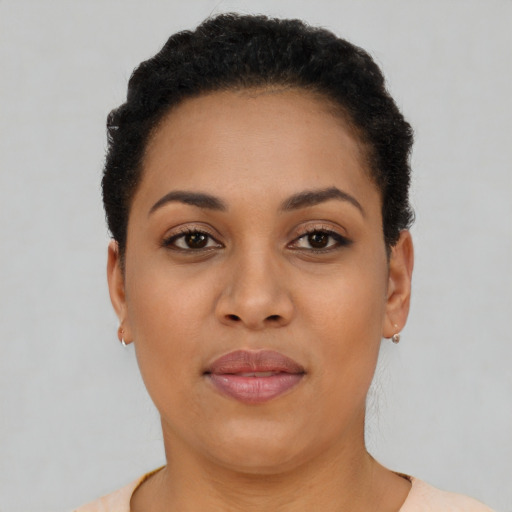 Joyful latino young-adult female with short  brown hair and brown eyes