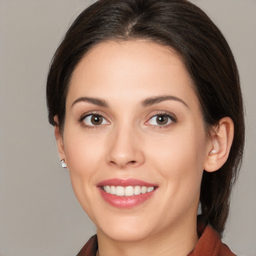 Joyful white young-adult female with medium  brown hair and brown eyes