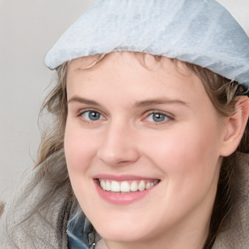 Joyful white young-adult female with medium  brown hair and blue eyes