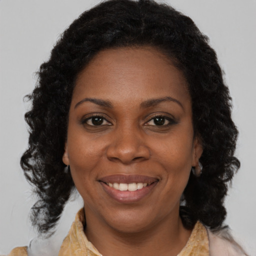 Joyful black young-adult female with medium  brown hair and brown eyes