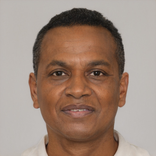 Joyful black adult male with short  brown hair and brown eyes