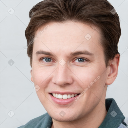 Joyful white young-adult female with short  brown hair and grey eyes