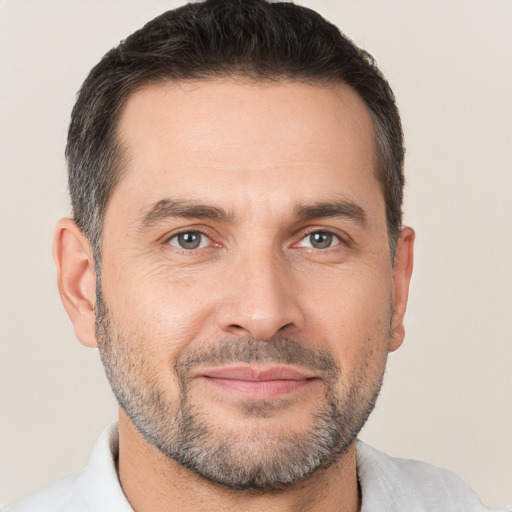 Joyful white adult male with short  brown hair and brown eyes