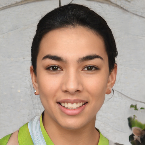 Joyful latino young-adult female with short  brown hair and brown eyes