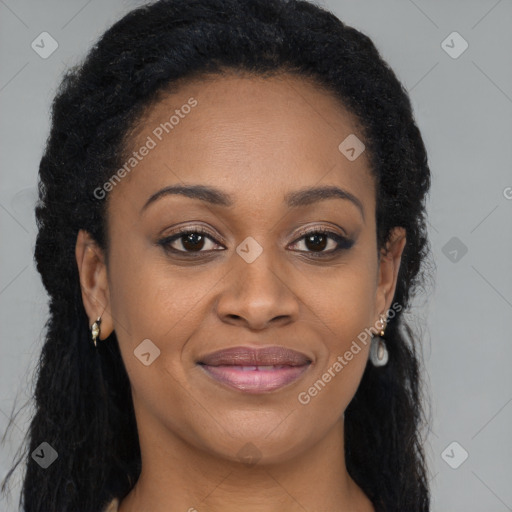 Joyful black adult female with long  brown hair and brown eyes