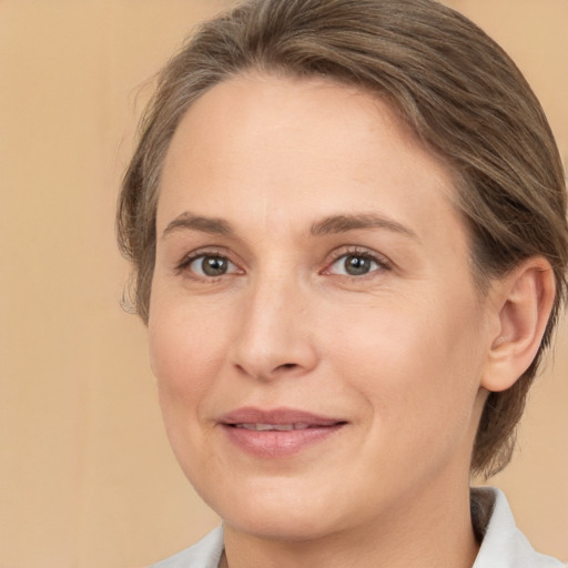 Joyful white adult female with medium  brown hair and brown eyes