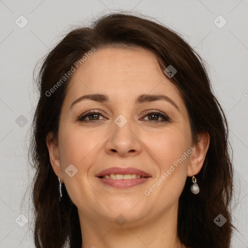 Joyful white adult female with long  brown hair and brown eyes