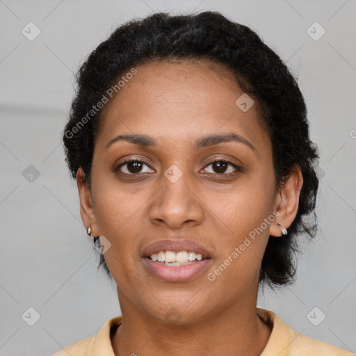 Joyful black young-adult female with short  brown hair and brown eyes