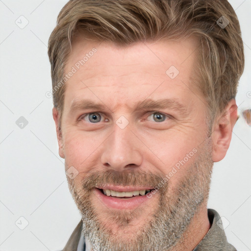 Joyful white adult male with short  brown hair and grey eyes