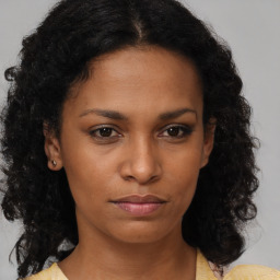 Neutral black young-adult female with medium  brown hair and brown eyes