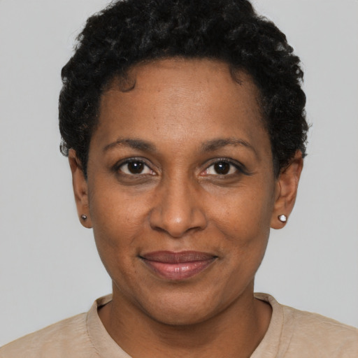 Joyful black adult female with short  black hair and brown eyes