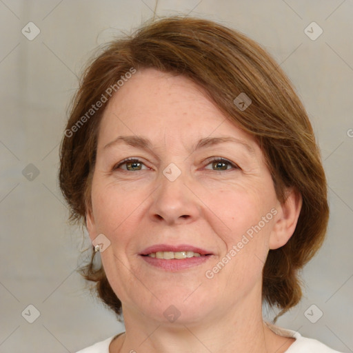 Joyful white adult female with medium  brown hair and green eyes