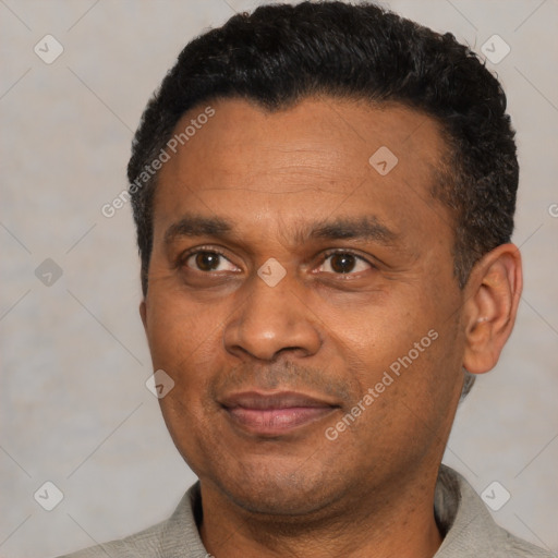 Joyful black adult male with short  black hair and brown eyes