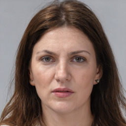 Joyful white adult female with long  brown hair and grey eyes