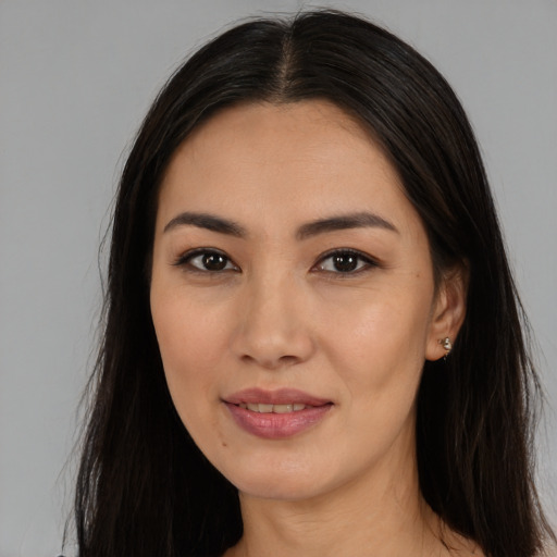 Joyful asian young-adult female with long  black hair and brown eyes
