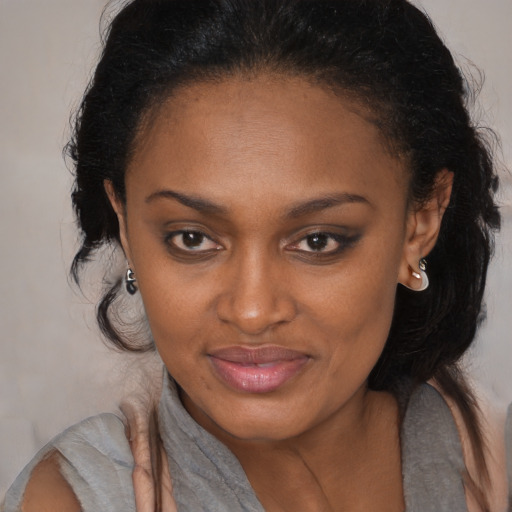 Joyful black young-adult female with medium  brown hair and brown eyes