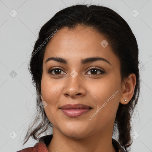 Joyful latino young-adult female with medium  brown hair and brown eyes