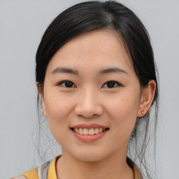 Joyful asian young-adult female with medium  brown hair and brown eyes