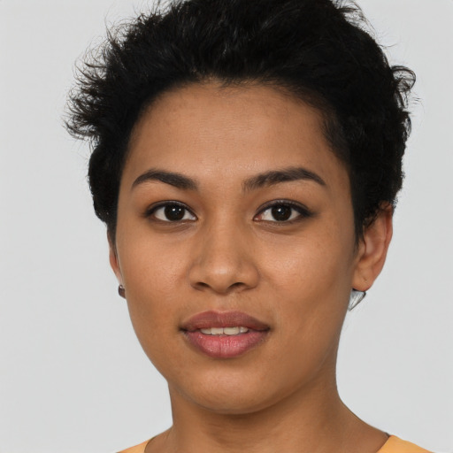 Joyful latino young-adult female with short  black hair and brown eyes