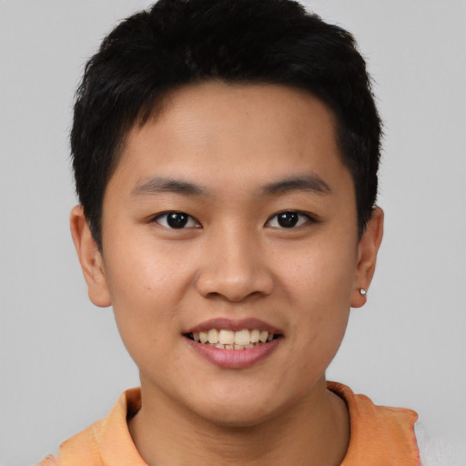 Joyful asian young-adult male with short  black hair and brown eyes