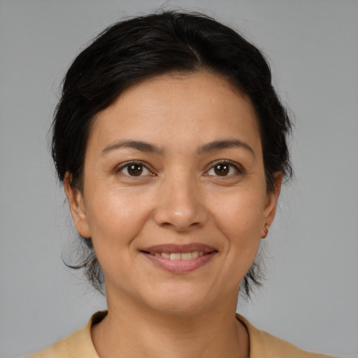 Joyful latino young-adult female with medium  brown hair and brown eyes