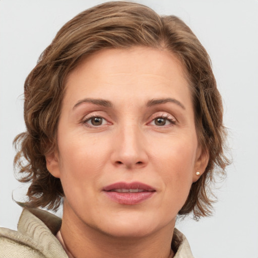 Joyful white adult female with medium  brown hair and grey eyes